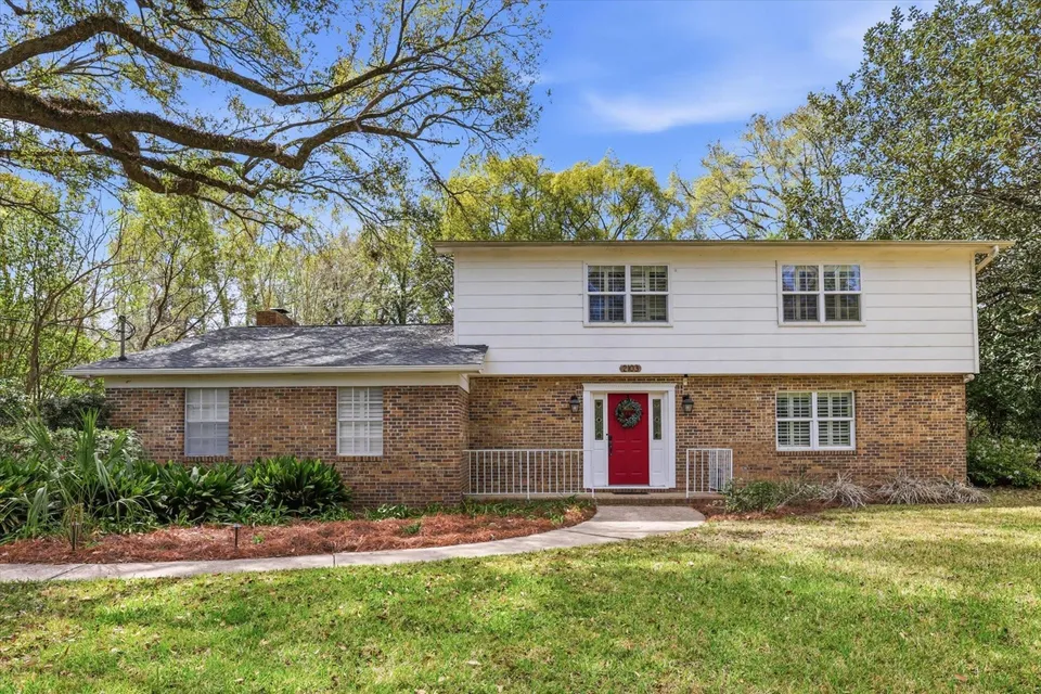 Two-story brick house with red door