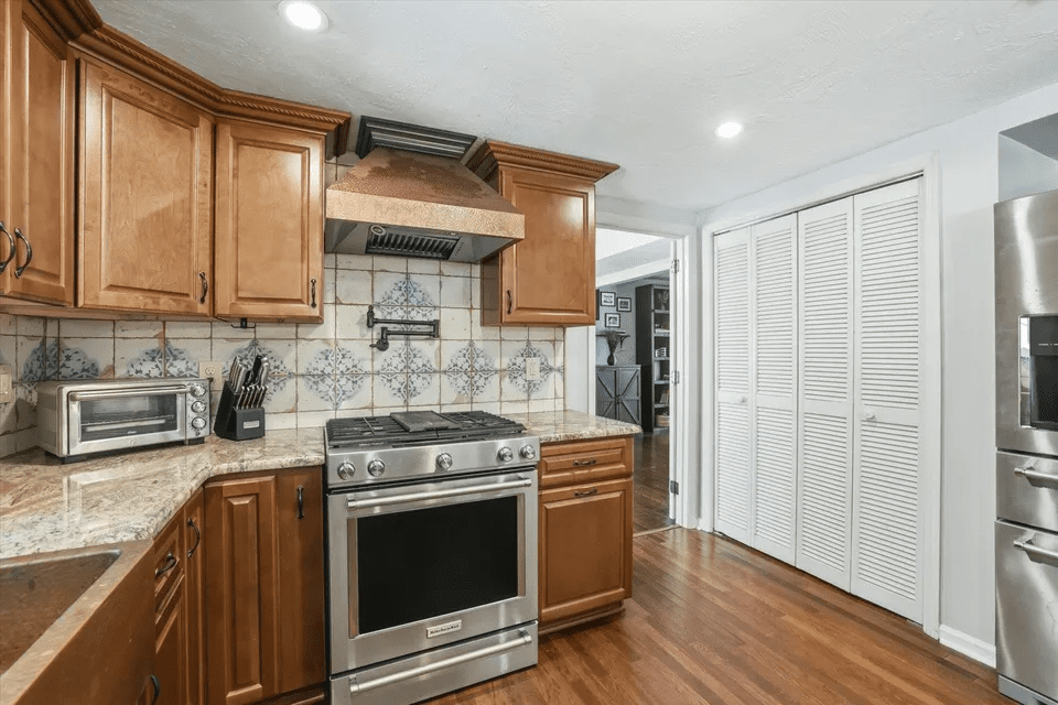 Wooden cabinets and tile backsplash