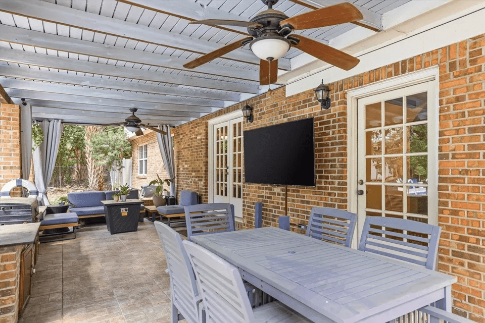 Covered patio with dining set and TV