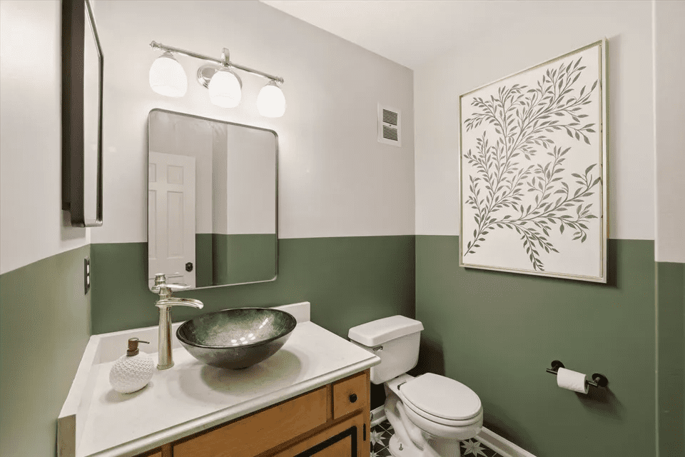 Bathroom with vessel sink and artwork