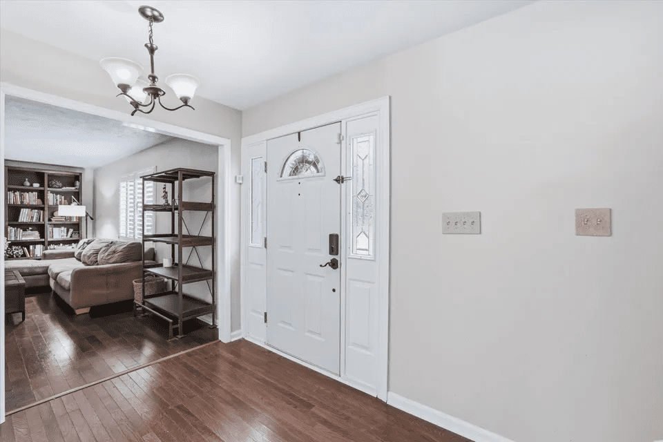 White front door and wooden floor entryway