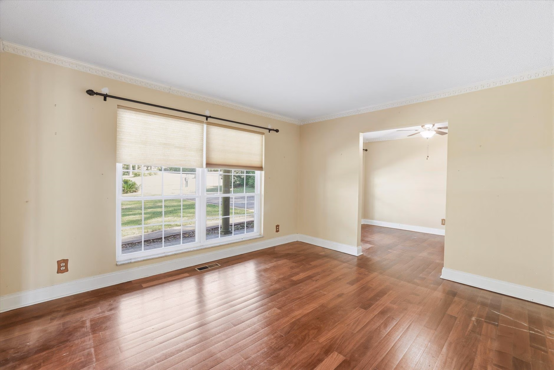 Bright living room with large windows and wood flooring.