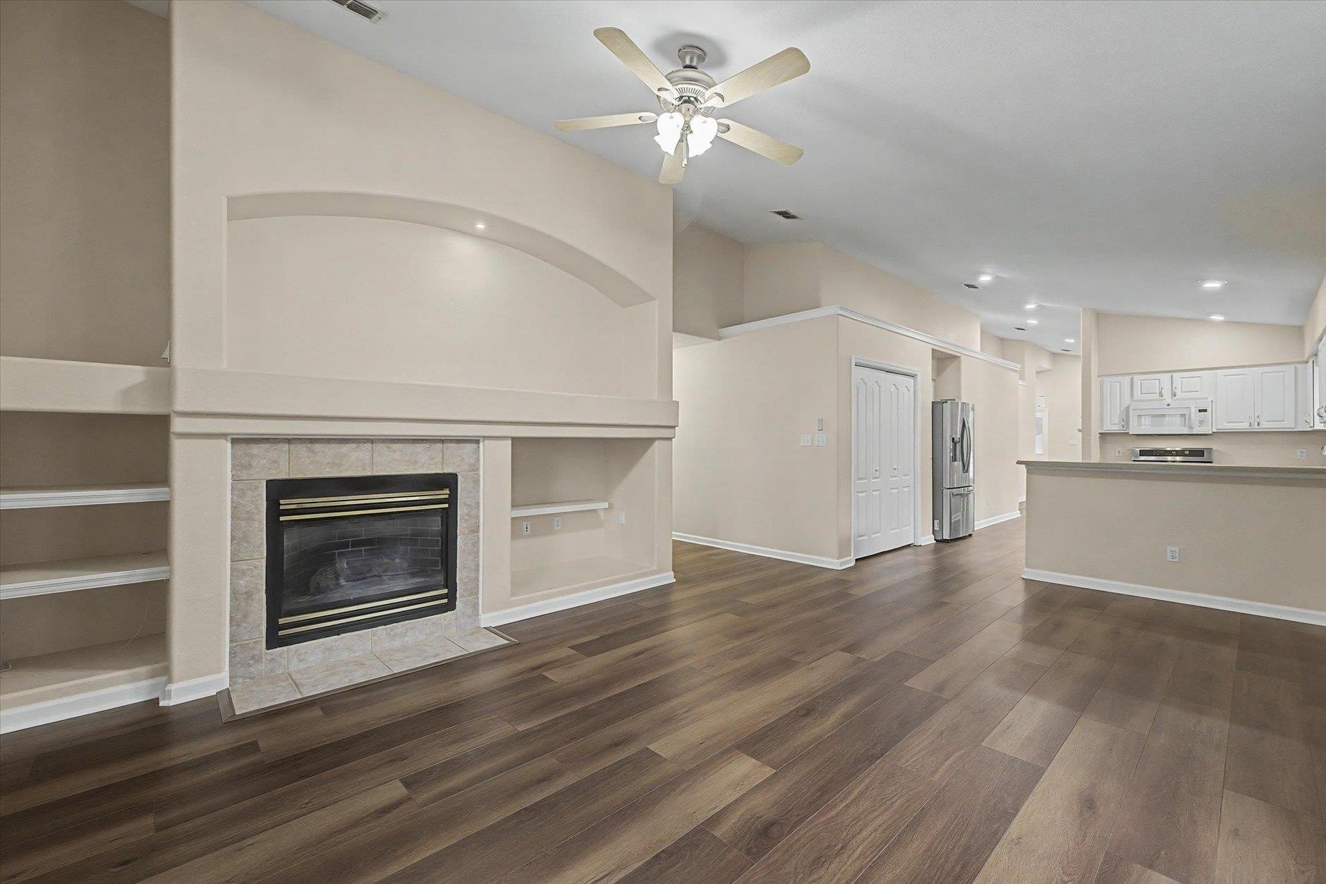 Modern living room with fireplace and hardwood floors.