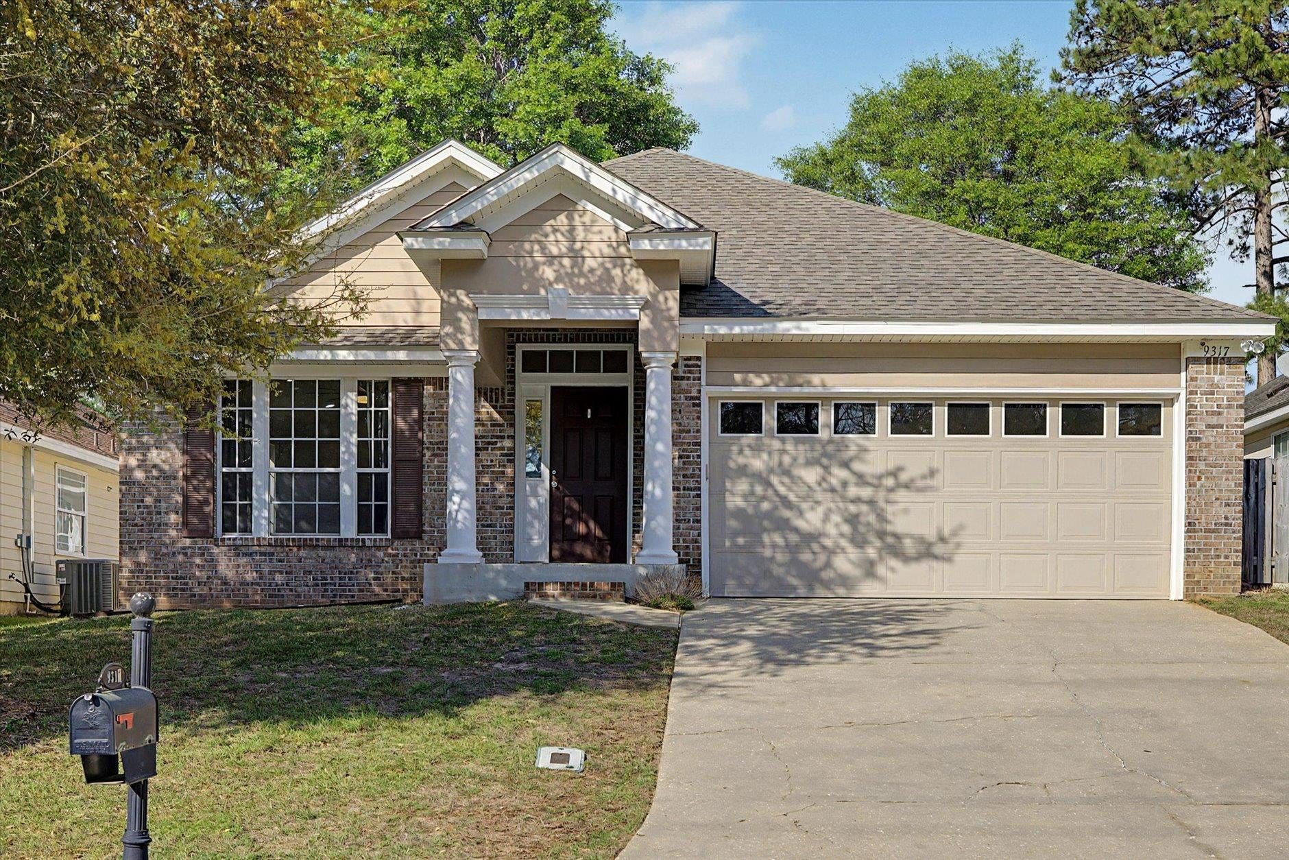 Single-story brick house with attached garage and front porch.